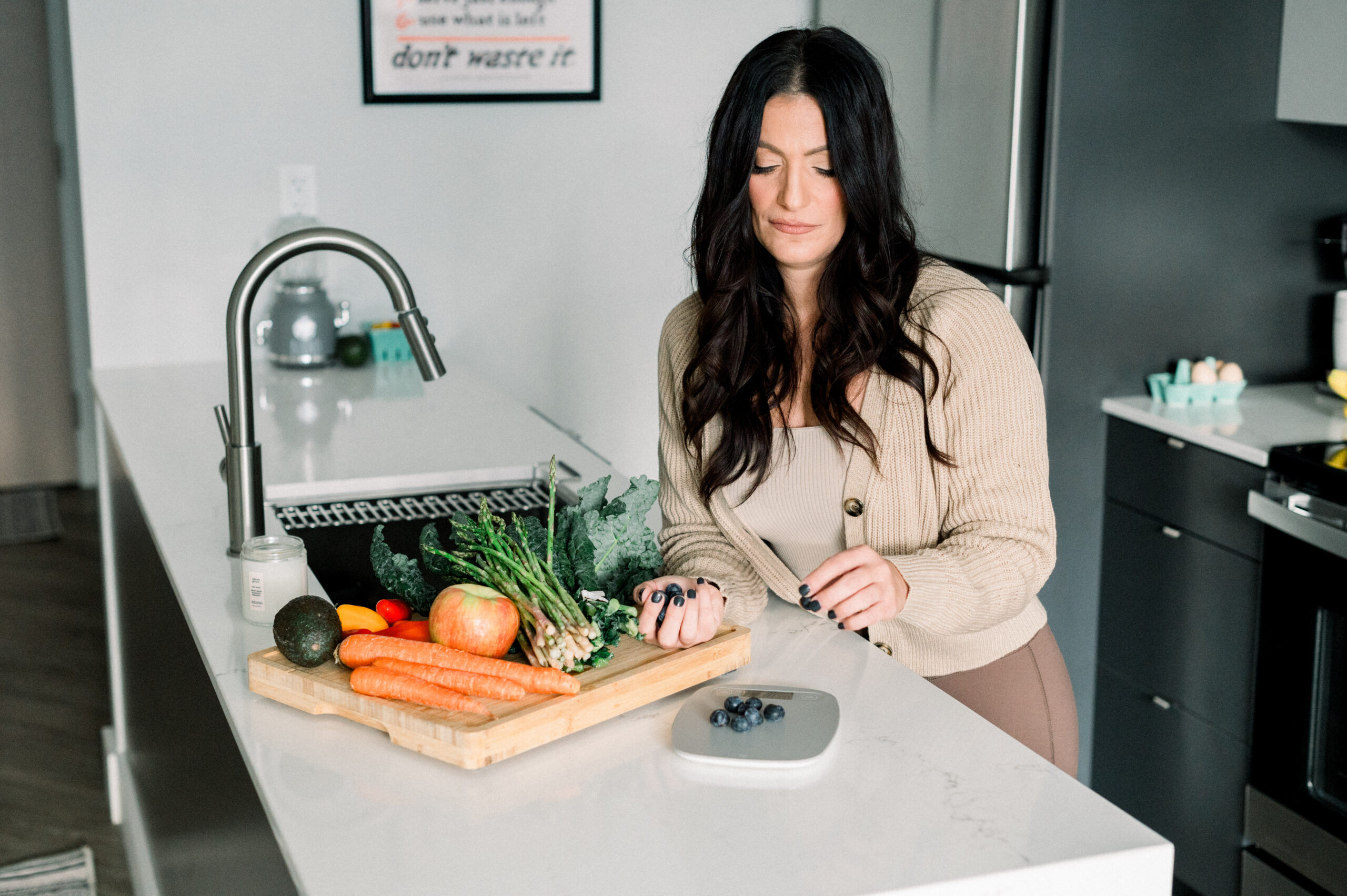 woman in kitchen, foods on cutting board