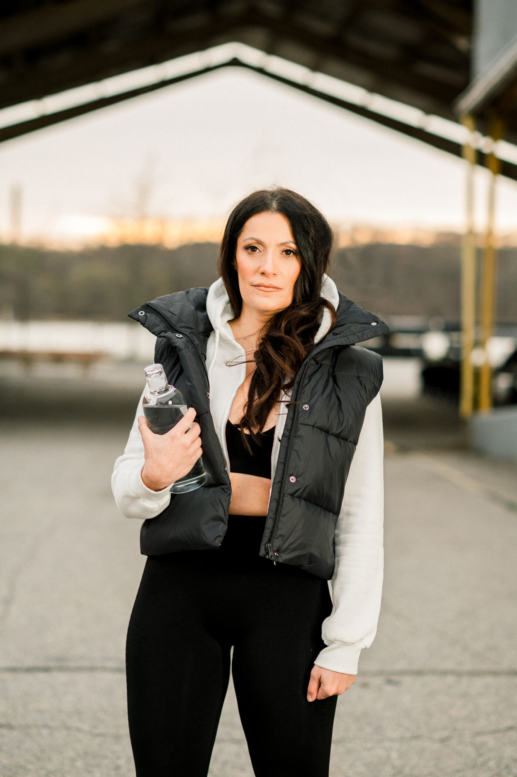 woman standing outside holding water bottle