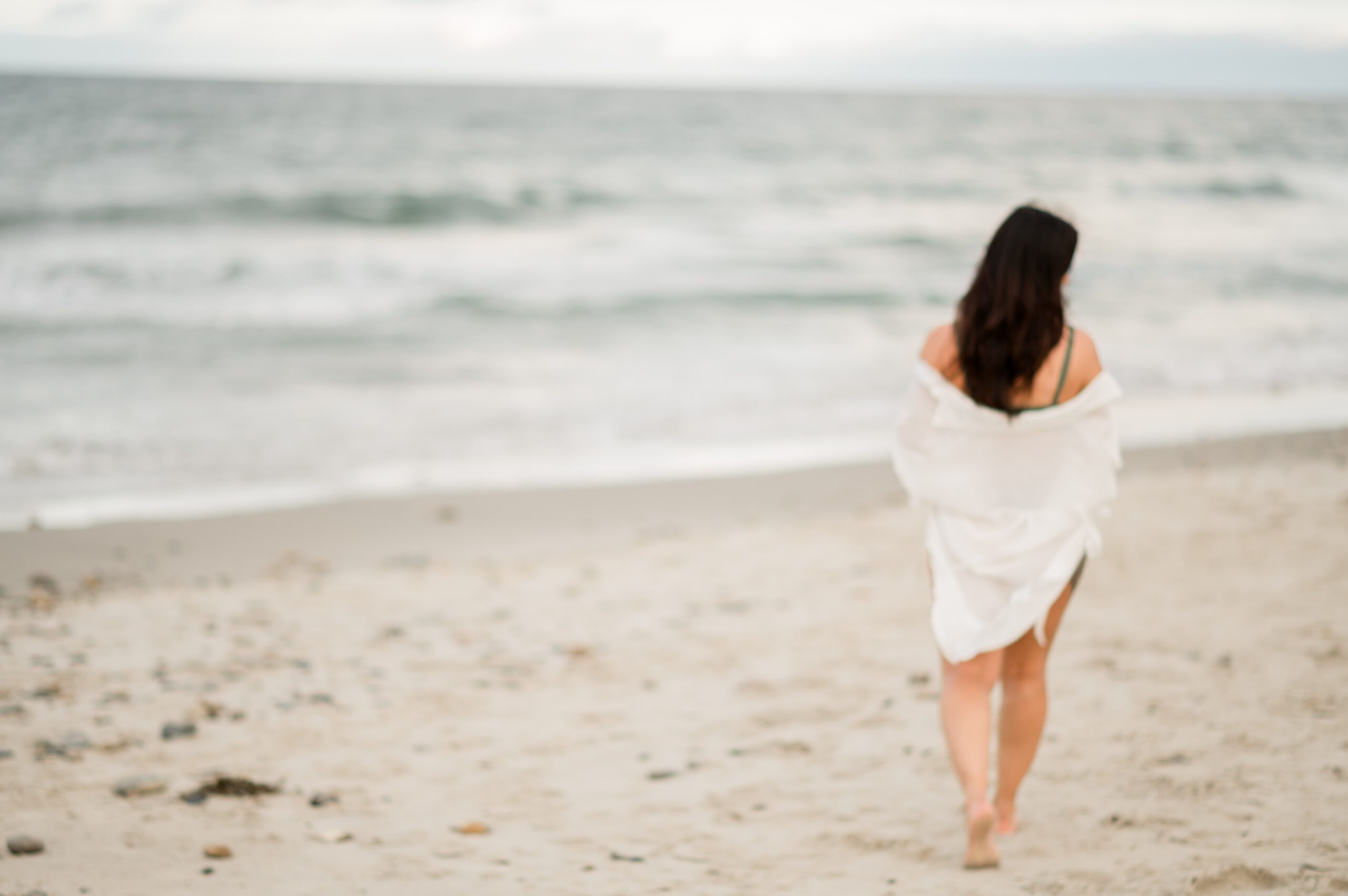 woman walking alone on the beach
