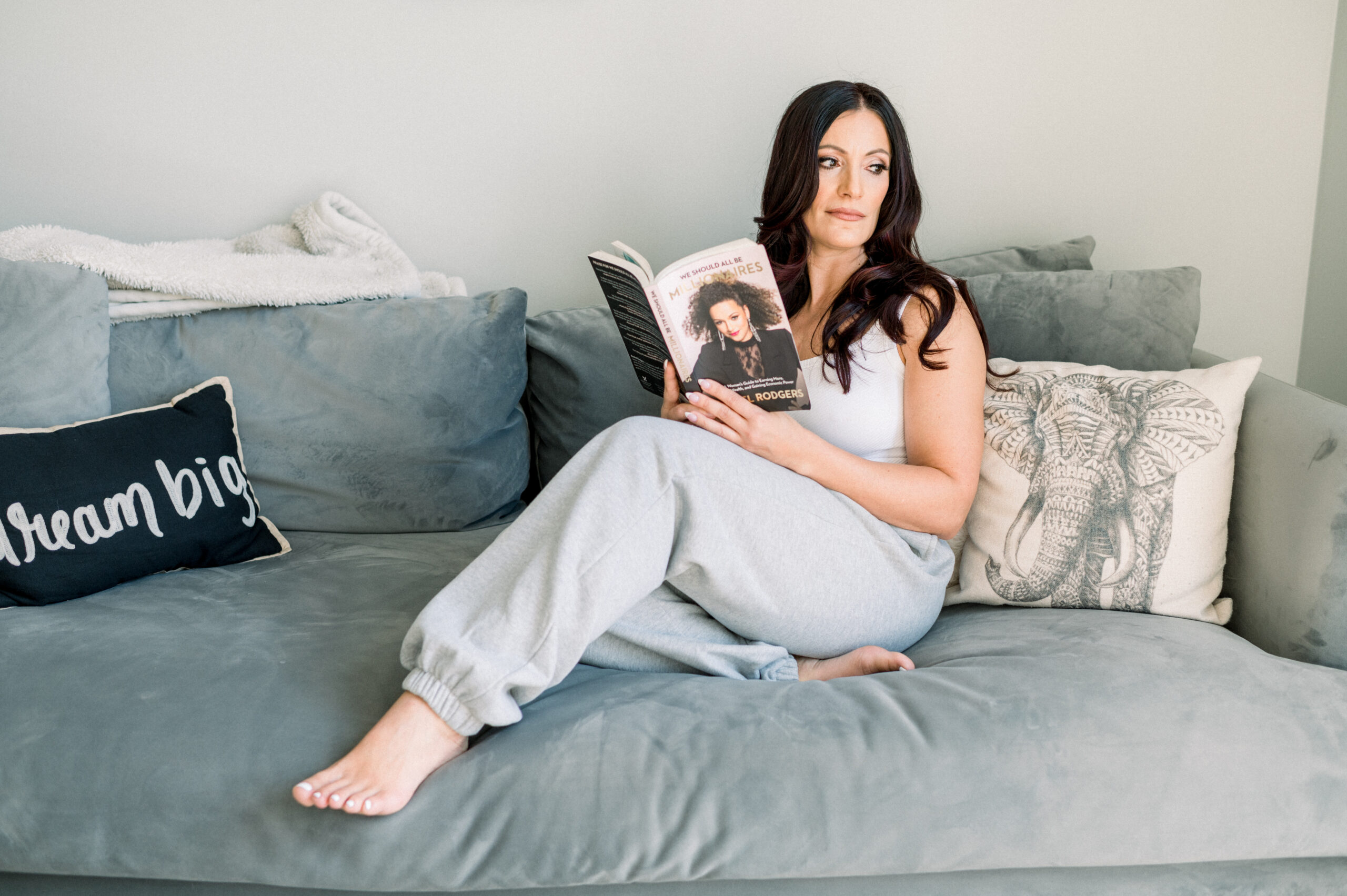 woman sitting on the sofa with a book